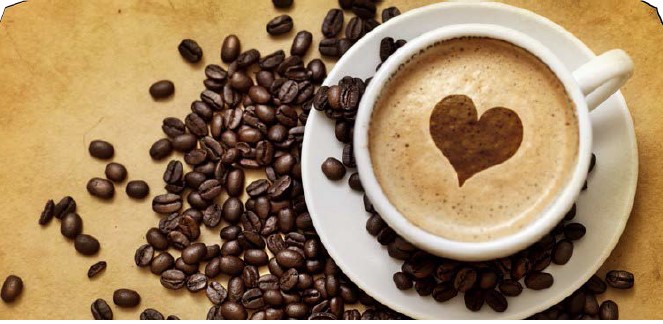 coffee with a heart in a cup and coffee beans on saucer and table