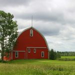 Red barn, green tree, green field