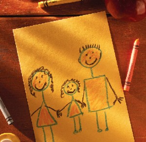 crayon drawing of a family on yellow paper