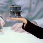 person signing a contract overlay of a house in hand of realtor
