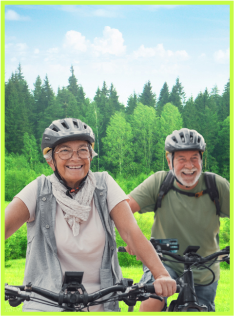 older couple wearing bike helmets biking