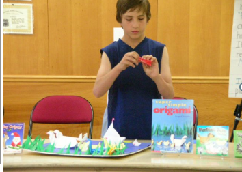 boy demonstrating oragami